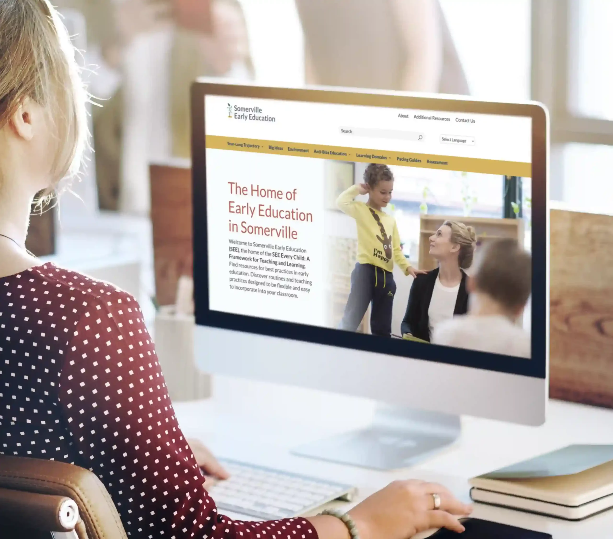 Woman at desk navigating the Somerville Early Education website